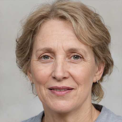 Joyful white middle-aged female with medium  brown hair and grey eyes