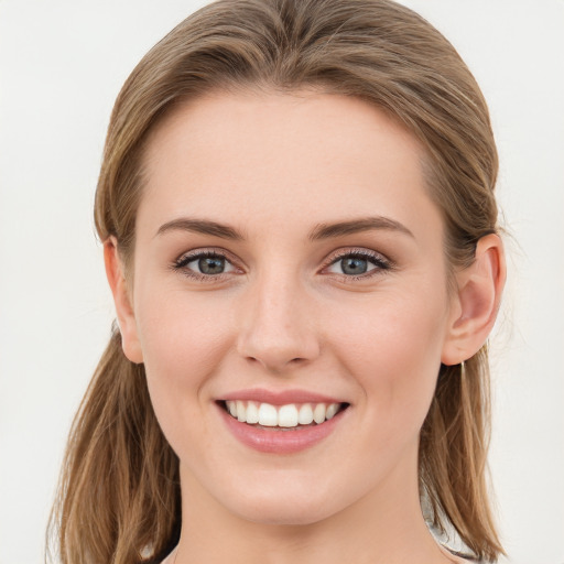 Joyful white young-adult female with long  brown hair and blue eyes