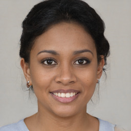 Joyful black young-adult female with medium  brown hair and brown eyes