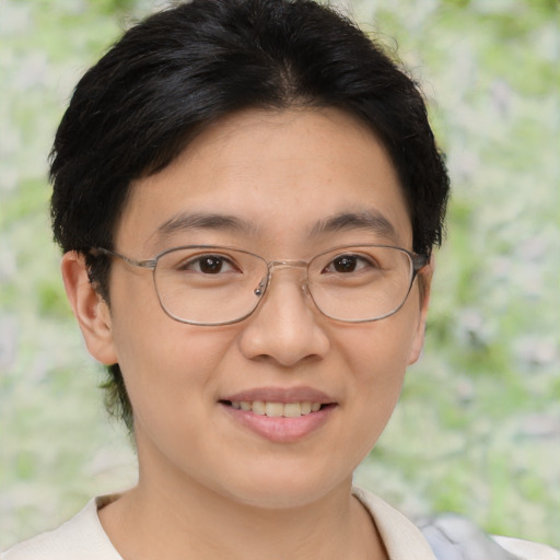 Joyful asian young-adult female with short  brown hair and brown eyes