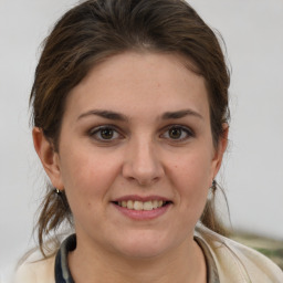 Joyful white young-adult female with medium  brown hair and grey eyes