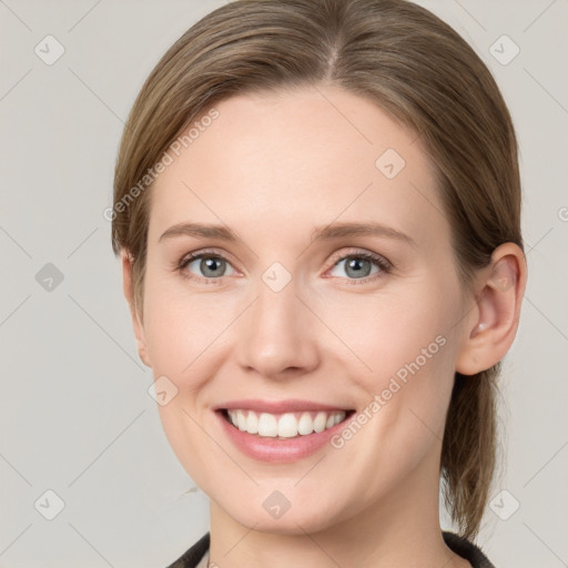 Joyful white young-adult female with medium  brown hair and grey eyes