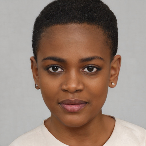 Joyful black child female with short  brown hair and brown eyes