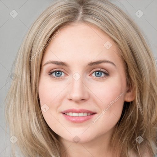 Joyful white young-adult female with long  brown hair and blue eyes