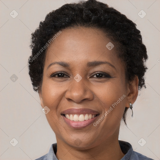 Joyful black adult female with short  brown hair and brown eyes