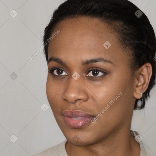 Joyful black young-adult female with short  brown hair and brown eyes