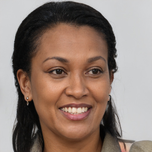 Joyful latino adult female with long  brown hair and brown eyes