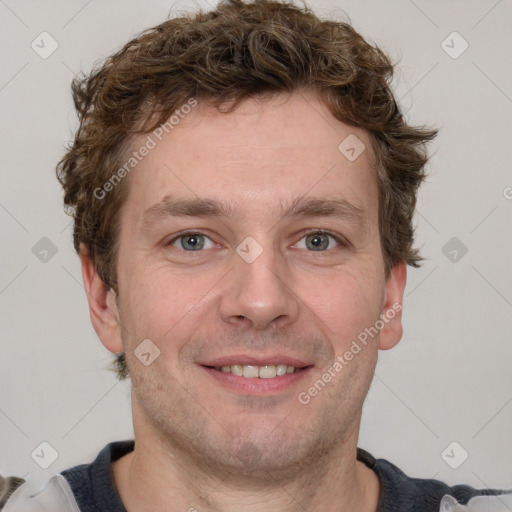 Joyful white adult male with short  brown hair and grey eyes