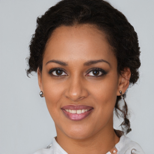 Joyful black young-adult female with short  brown hair and brown eyes