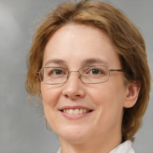 Joyful white adult female with medium  brown hair and blue eyes