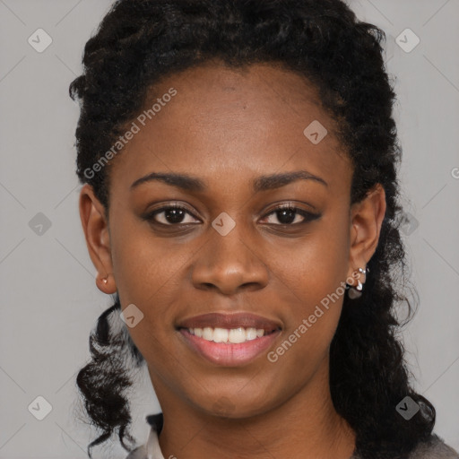 Joyful black young-adult female with long  black hair and brown eyes