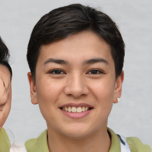 Joyful asian young-adult female with short  brown hair and brown eyes