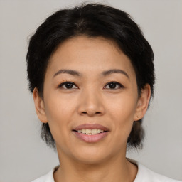 Joyful asian young-adult female with medium  black hair and brown eyes