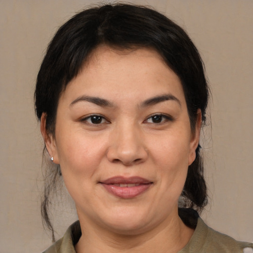 Joyful white adult female with medium  brown hair and brown eyes