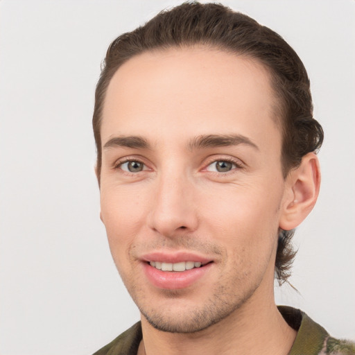 Joyful white young-adult male with short  brown hair and brown eyes