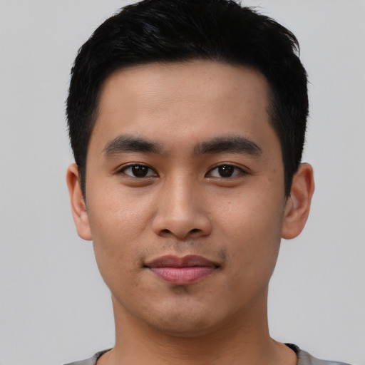 Joyful asian young-adult male with short  black hair and brown eyes