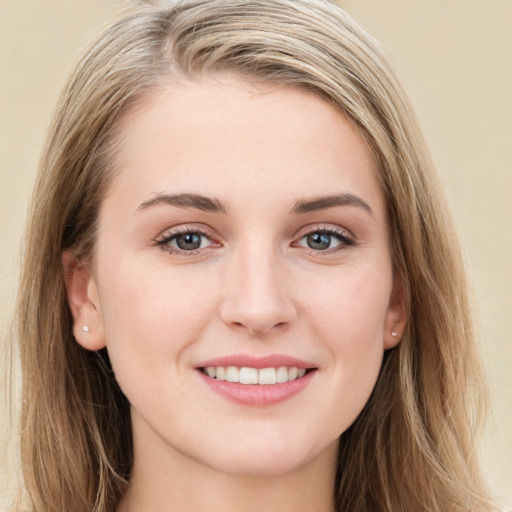 Joyful white young-adult female with long  brown hair and blue eyes