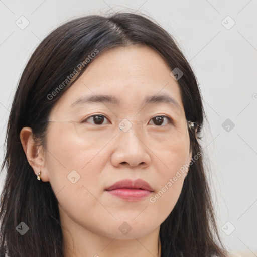 Joyful asian young-adult female with long  brown hair and brown eyes