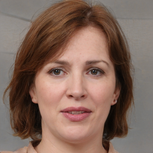 Joyful white adult female with medium  brown hair and grey eyes