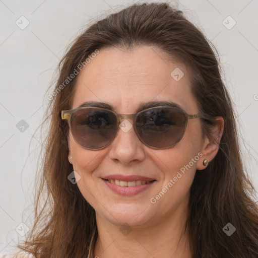 Joyful white adult female with long  brown hair and brown eyes