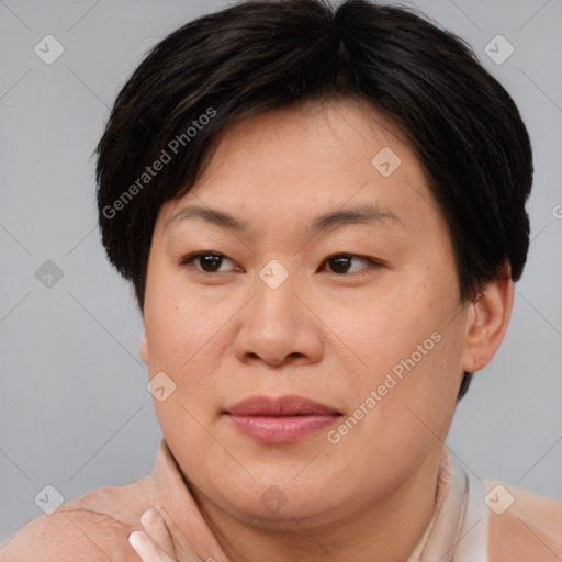 Joyful asian adult female with short  brown hair and brown eyes