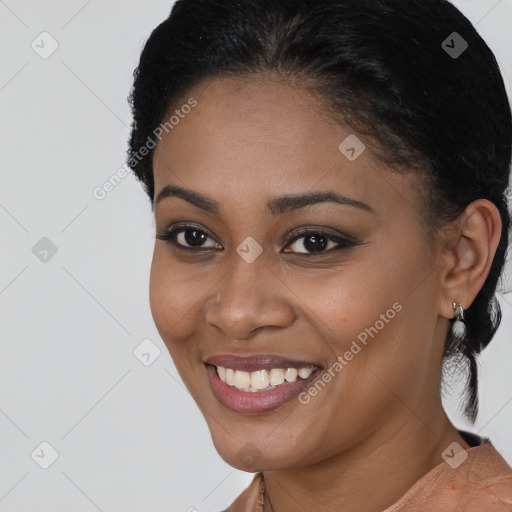 Joyful black young-adult female with short  black hair and brown eyes