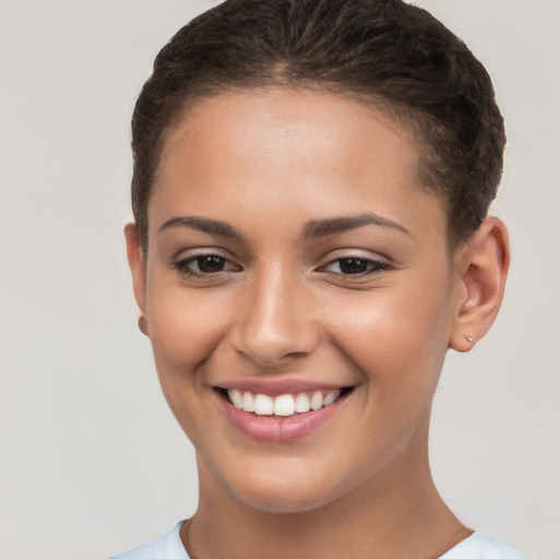 Joyful white young-adult female with short  brown hair and brown eyes