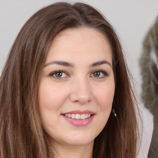 Joyful white young-adult female with long  brown hair and brown eyes