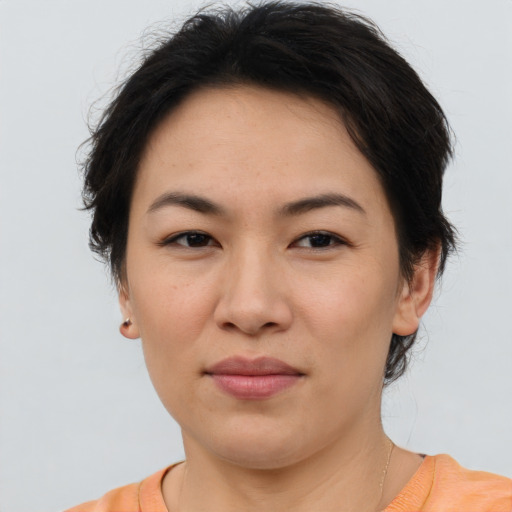 Joyful asian adult female with short  brown hair and brown eyes
