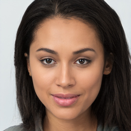 Joyful latino young-adult female with long  brown hair and brown eyes