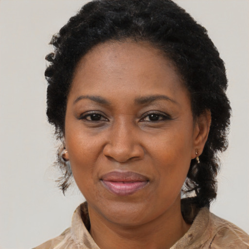 Joyful black adult female with medium  black hair and brown eyes