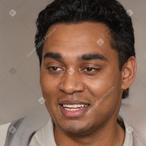 Joyful black young-adult male with short  black hair and brown eyes