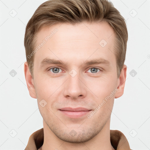 Joyful white young-adult male with short  brown hair and grey eyes