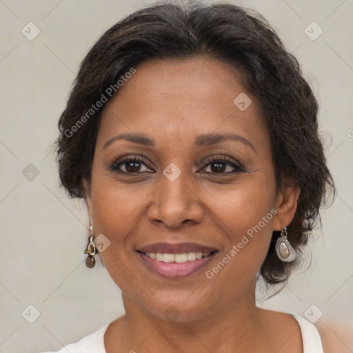 Joyful black adult female with medium  brown hair and brown eyes