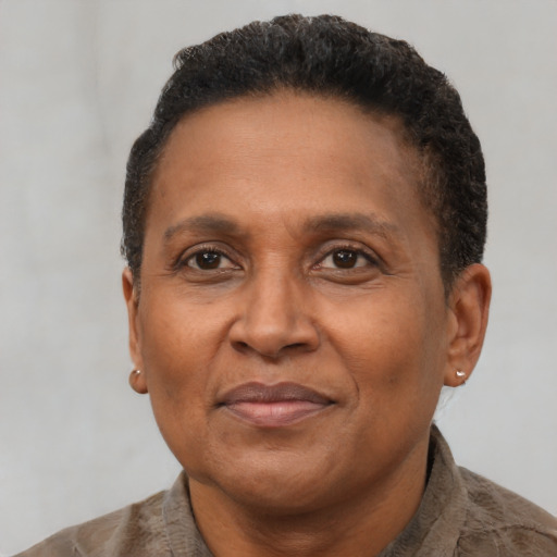 Joyful latino adult female with short  brown hair and brown eyes
