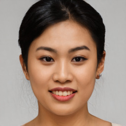 Joyful asian young-adult female with medium  brown hair and brown eyes