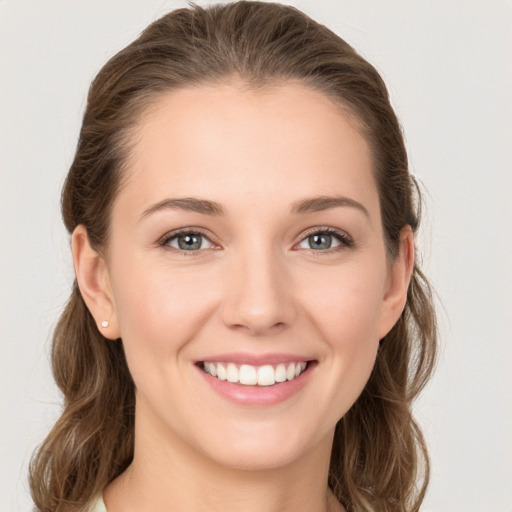 Joyful white young-adult female with long  brown hair and grey eyes