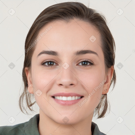 Joyful white young-adult female with medium  brown hair and grey eyes