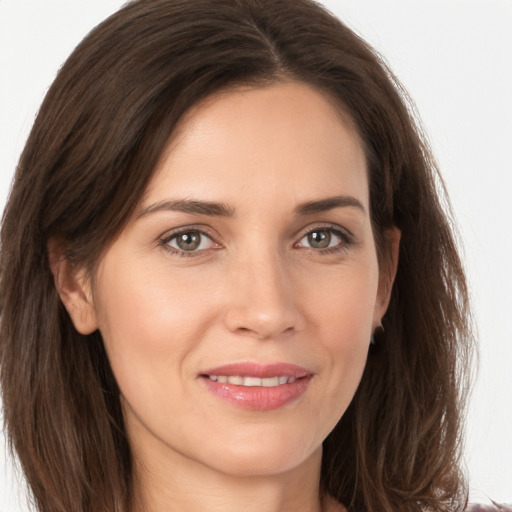 Joyful white young-adult female with long  brown hair and grey eyes