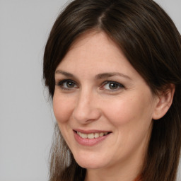 Joyful white adult female with medium  brown hair and brown eyes