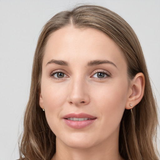 Joyful white young-adult female with long  brown hair and grey eyes