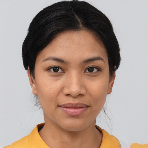 Joyful asian young-adult female with medium  brown hair and brown eyes