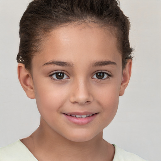 Joyful white child female with short  brown hair and brown eyes