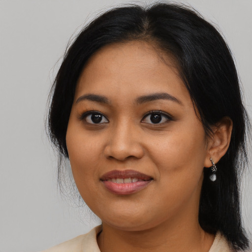Joyful asian young-adult female with long  black hair and brown eyes