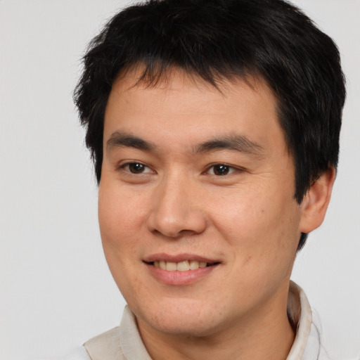 Joyful asian young-adult male with short  brown hair and brown eyes