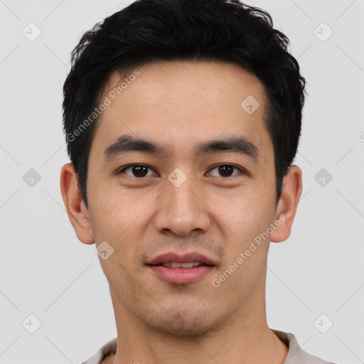 Joyful asian young-adult male with short  black hair and brown eyes