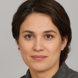 Joyful white adult female with medium  brown hair and brown eyes