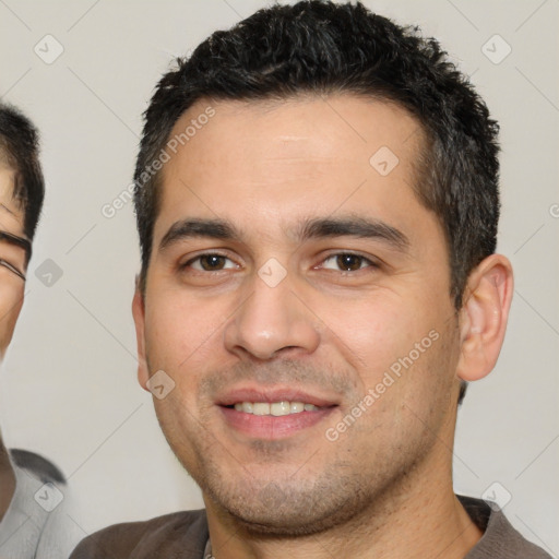 Joyful white young-adult male with short  black hair and brown eyes