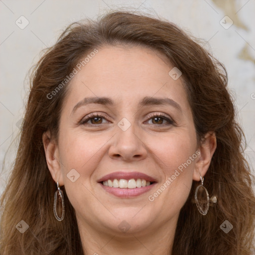 Joyful white adult female with long  brown hair and grey eyes