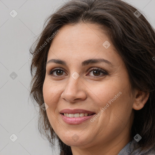 Joyful white adult female with long  brown hair and brown eyes